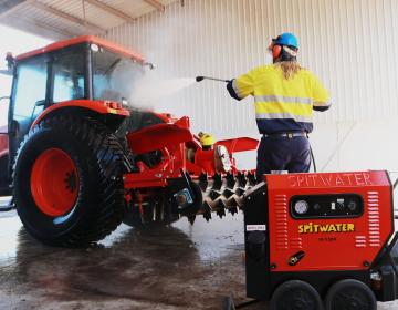 high pressure cleaning a tractor